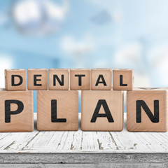 Wooden blocks spelling out “Dental Plan”