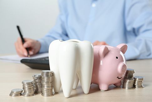 Coins next to a piggy bank