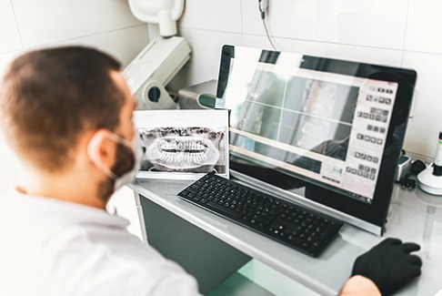 dentist examining x-ray