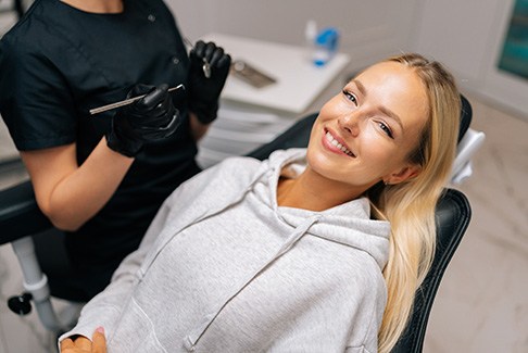 Patient reclined in treatment chair smiling