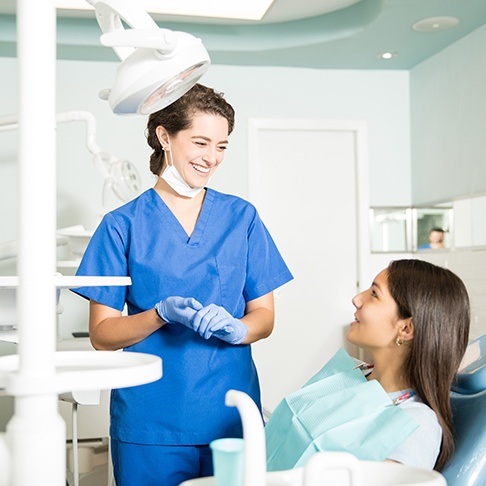 Teen smiling at dentist in treatment chair