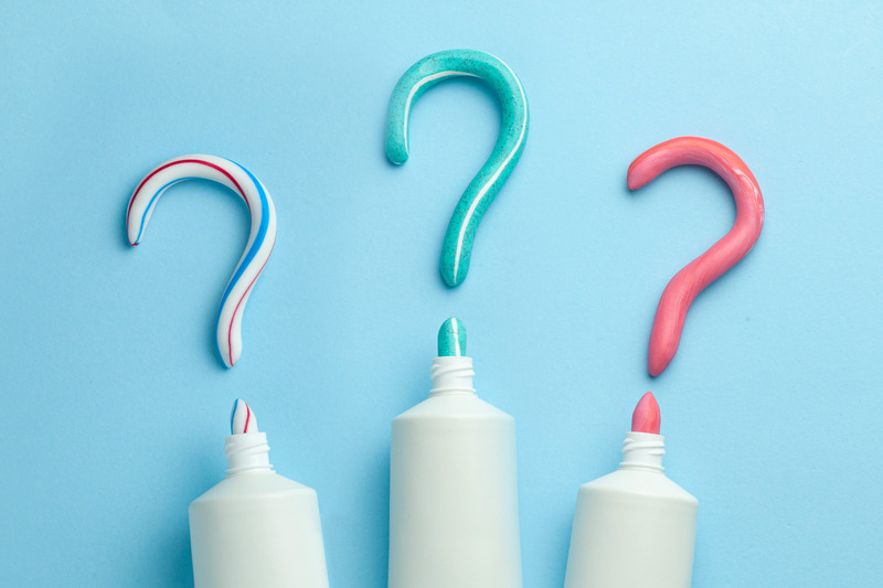 Tubes of toothpaste forming question marks