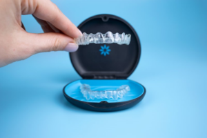 Hand lifting Invisalign tray out of its case