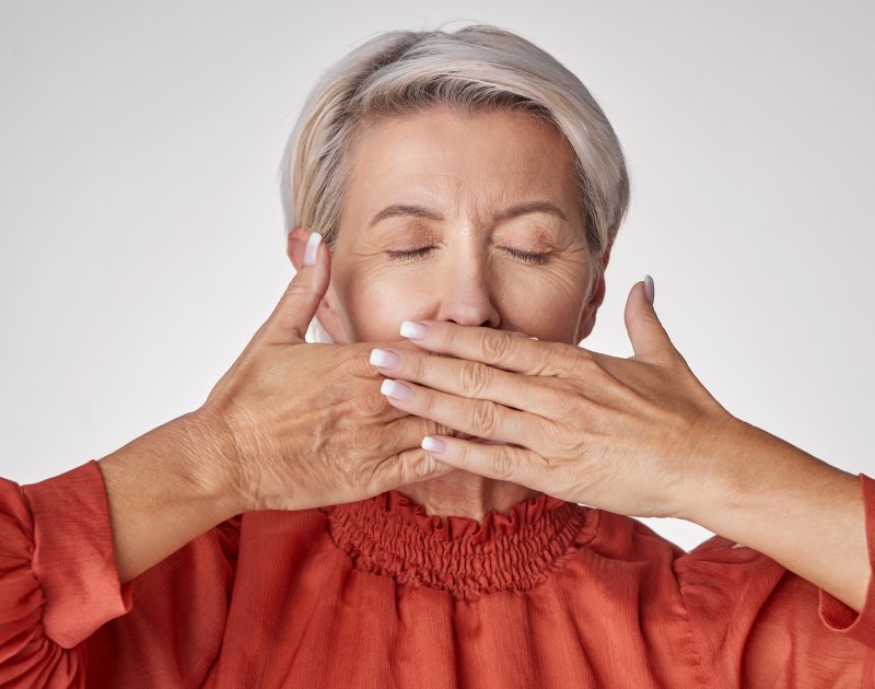 Lady protects teeth from view